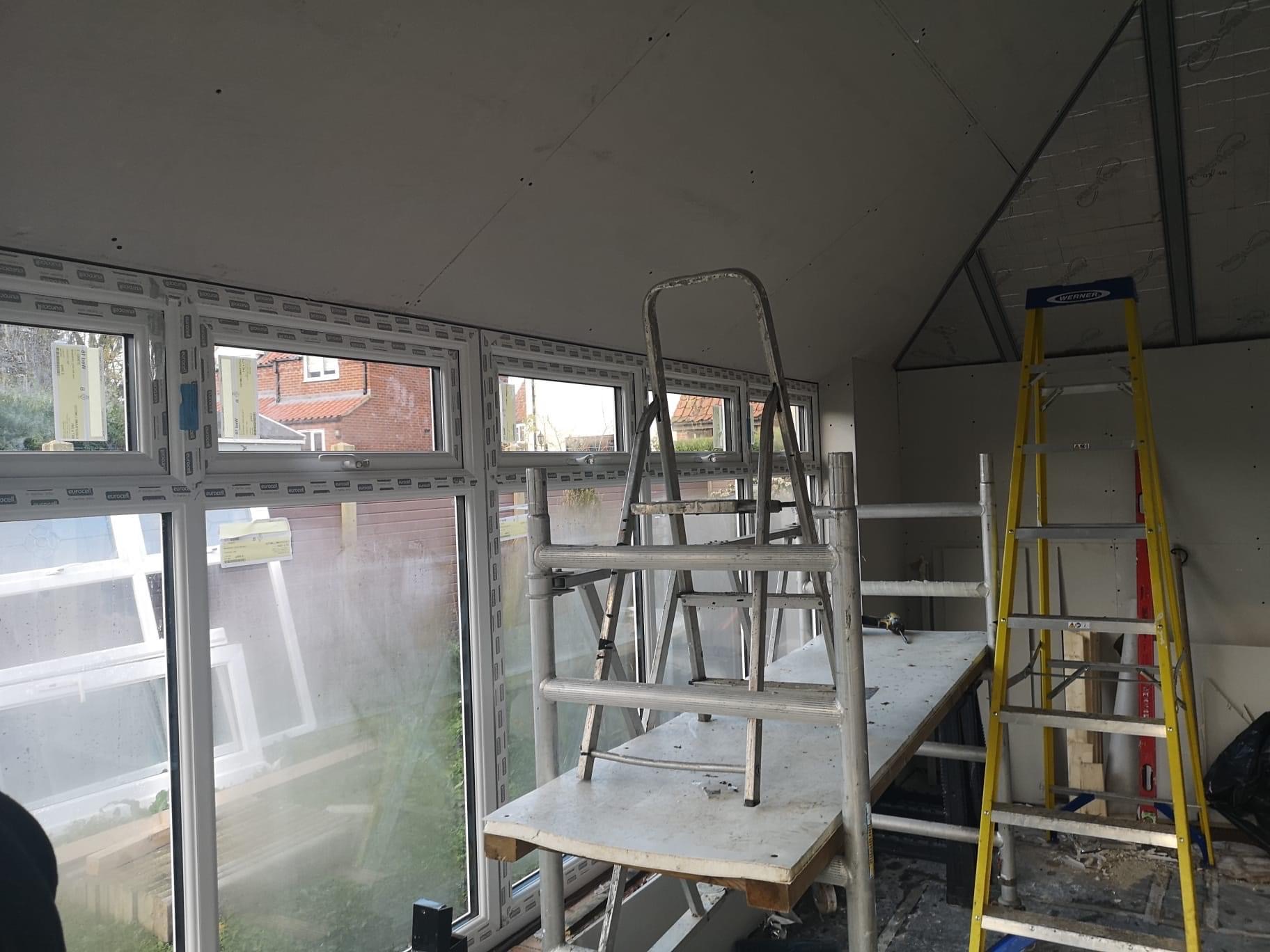 Construction work of conservatory roof with ladders